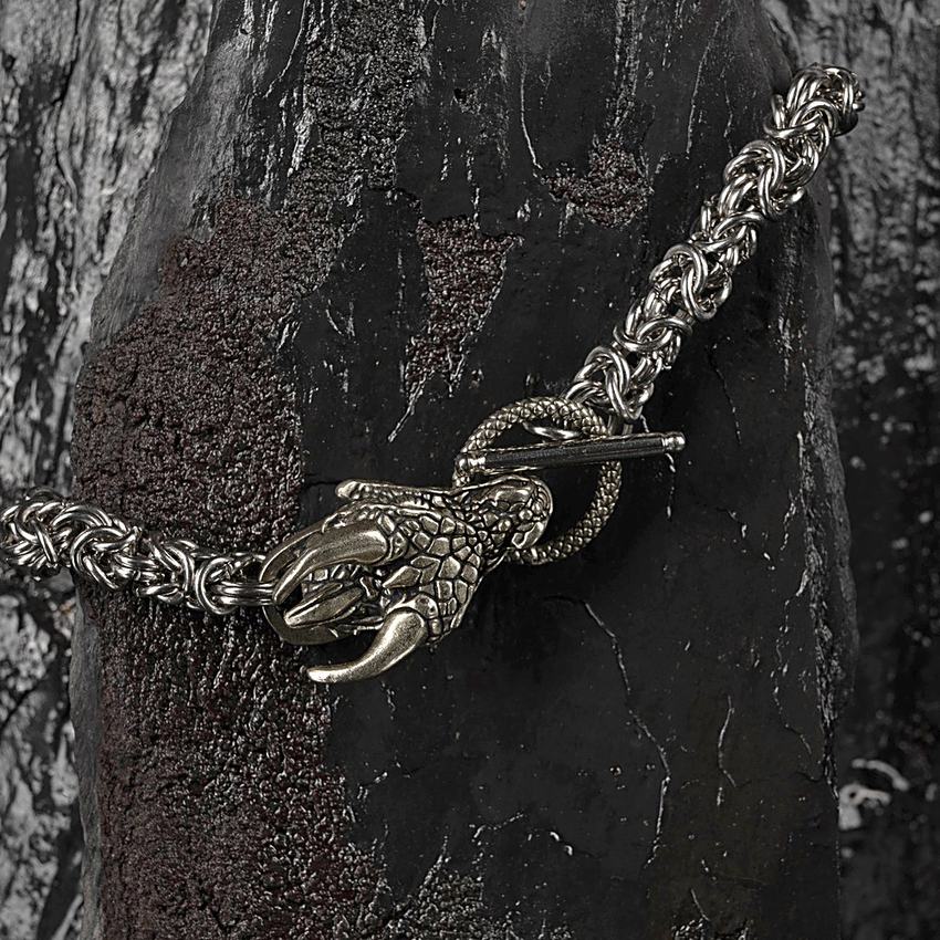 Cast dragon-head toggle clasp joined to Byzantine weave