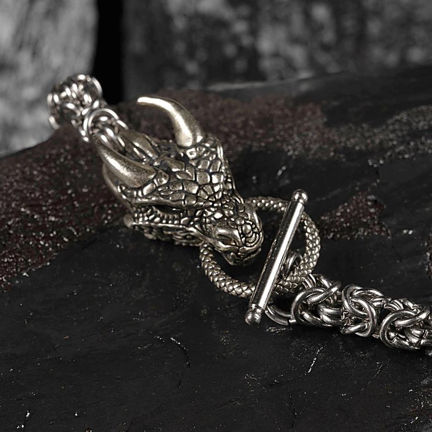 Detail of a cast dragon-head clasp showing scale and horn work
